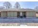 Exterior view of single-story home with concrete porch and yard featuring mature trees on a sunny day at 3652 Yellow Poplar Ct, Indianapolis, IN 46222