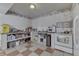 Functional kitchen featuring white appliances, tiled floor, and ample countertops at 3652 Yellow Poplar Ct, Indianapolis, IN 46222