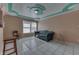 Bright living room with tiled floors, stylish ceiling accents, and a comfortable blue sofa at 3652 Yellow Poplar Ct, Indianapolis, IN 46222