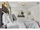 King bed in main bedroom suite with elegant décor and a view to the ensuite bathroom at 3769 Cantebury Dr, Franklin, IN 46131