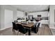 Open-concept dining area features a dark wood table with seating for six and modern black woven chairs at 3871 Flora Dr, Franklin, IN 46131