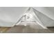 Unique attic space with angled ceilings, carpet flooring, and window light at 39 S Holmes Ave, Indianapolis, IN 46222