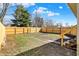 Spacious backyard features a full wood fence, a stone border, and stairs leading to a deck or porch at 39 S Holmes Ave, Indianapolis, IN 46222
