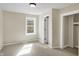 This bedroom is bathed in natural light, highlighting its plush carpeting and closet at 39 S Holmes Ave, Indianapolis, IN 46222
