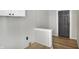Hallway featuring hardwood floors and gray front door at 39 S Holmes Ave, Indianapolis, IN 46222
