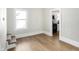 Hallway with hardwood floors and a view of the kitchen with black appliances at 39 S Holmes Ave, Indianapolis, IN 46222