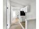 Bright hallway with light-colored wood floors providing glimpses into other rooms at 39 S Holmes Ave, Indianapolis, IN 46222