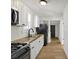 Efficient kitchen with white cabinets, black appliances, and butcher block countertops at 39 S Holmes Ave, Indianapolis, IN 46222