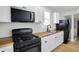 Well-lit kitchen featuring butcher block countertops, black appliances, and white cabinetry at 39 S Holmes Ave, Indianapolis, IN 46222