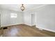 Inviting living room boasting hardwood floors and a stylish light fixture at 39 S Holmes Ave, Indianapolis, IN 46222