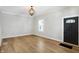 Bright living room features hardwood floors, modern light fixture, and neutral paint at 39 S Holmes Ave, Indianapolis, IN 46222