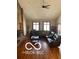 Spacious living room with vaulted ceilings, hardwood floors, and a comfortable black leather sofa at 4031 N Banta Rd, Bargersville, IN 46106