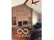 Cozy living room featuring a brick fireplace, hardwood floors, and a beamed ceiling at 4031 N Banta Rd, Bargersville, IN 46106