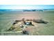 Aerial view showcasing a rural property with a house, outbuilding, gravel driveway, and surrounding farmland under a blue sky at 4254 N 200 W, Greenfield, IN 46140