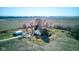 An aerial view of a charming farmhouse with outbuildings, surrounded by expansive farmland at 4254 N 200 W, Greenfield, IN 46140