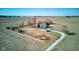 A beautiful rural property featuring a cozy home with a garage and driveway surrounded by open fields on a sunny day at 4254 N 200 W, Greenfield, IN 46140