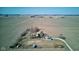 Aerial view showcasing a farmhouse with green roof with surrounding fields and outbuildings at 4254 N 200 W, Greenfield, IN 46140