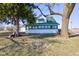 Quaint two-story home with green roof, surrounded by mature trees and a fire pit in a spacious yard at 4254 N 200 W, Greenfield, IN 46140
