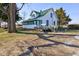 Two-story home with green roof and inviting deck, complemented by mature trees and ample outdoor space at 4254 N 200 W, Greenfield, IN 46140