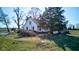 Classic farmhouse with mature trees and a propane tank on a lush, grassy lawn at 4254 N 200 W, Greenfield, IN 46140