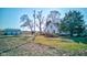 Quaint farmhouse with detached garage surrounded by lush greenery and mature trees at 4254 N 200 W, Greenfield, IN 46140
