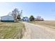 Two-story home with a green roof and matching storage shed, set back on a spacious lot with a long driveway at 4254 N 200 W, Greenfield, IN 46140