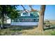 Charming country home with enclosed porch, surrounded by trees and natural landscaping on a sunny day at 4254 N 200 W, Greenfield, IN 46140