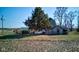 Rustic farm house with weathered shed and propane tank nestled among mature trees at 4254 N 200 W, Greenfield, IN 46140