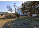 Exterior view of a white house with green trim and mature trees on a sunny day at 4254 N 200 W, Greenfield, IN 46140