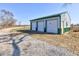 Versatile three-car garage, ideal for secure storage of vehicles and equipment, and gravel driveway at 4254 N 200 W, Greenfield, IN 46140