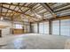 Large garage interior with a concrete floor, wooden trusses, and plenty of space for projects at 4254 N 200 W, Greenfield, IN 46140