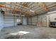 Spacious garage interior featuring a high ceiling, concrete floor, and room for vehicles or equipment at 4254 N 200 W, Greenfield, IN 46140