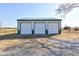 Durable three-car garage perfect for hobbies, storage, or workshop space with a gravel drive at 4254 N 200 W, Greenfield, IN 46140