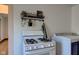 Gas range with shelf and hanging plants, plus a laundry machine at 4254 N 200 W, Greenfield, IN 46140