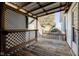 Inviting covered porch with wood floors, lattice privacy screen, and views of the surrounding property at 4254 N 200 W, Greenfield, IN 46140
