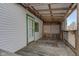 White exterior of porch showing a door with green trim and a wood lattice privacy panel at 4254 N 200 W, Greenfield, IN 46140