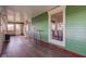 Spacious sunroom with wood floors, bright green walls, and lots of natural light from large windows at 4254 N 200 W, Greenfield, IN 46140