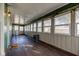 Bright sunroom with wood floors, green walls, large windows, and a vintage heater adding charm at 4254 N 200 W, Greenfield, IN 46140
