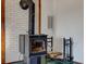 Close up of a vintage wood burning stove with brick surround and wood storage at 4254 N 200 W, Greenfield, IN 46140