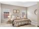 Cozy bedroom featuring neutral tones, two windows, and a comfortable bed with stylish linens at 4313 W Hidden Preserve Cv, New Palestine, IN 46163