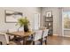 Charming dining room featuring a wooden table with seating, a shelf and natural light at 4313 W Hidden Preserve Cv, New Palestine, IN 46163
