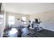 Bright fitness center equipped with treadmills, elliptical machines, and weightlifting equipment at 4313 W Hidden Preserve Cv, New Palestine, IN 46163