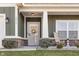 Charming home featuring an inviting front porch, brick accents, and beautifully landscaped front yard at 4313 W Hidden Preserve Cv, New Palestine, IN 46163