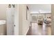 Hallway view with laundry area that leads to a bright living room with large windows at 4313 W Hidden Preserve Cv, New Palestine, IN 46163