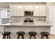 Close-up of a modern kitchen island with granite countertops, sleek fixtures, and stainless steel appliances at 4313 W Hidden Preserve Cv, New Palestine, IN 46163