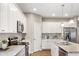 Modern kitchen with granite countertops, stylish backsplash, stainless steel appliances, and ample cabinet space at 4313 W Hidden Preserve Cv, New Palestine, IN 46163
