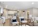 Bright, open-concept living room flowing into kitchen with modern furniture, hardwood floors and natural light at 4313 W Hidden Preserve Cv, New Palestine, IN 46163