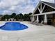 Community pool area with lounge chairs and tables, perfect for relaxation and recreation at 4313 W Hidden Preserve Cv, New Palestine, IN 46163