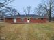 The backyard featuring a well-kept lawn of the single-story red brick home at 4530 Wichser Ct, Indianapolis, IN 46228