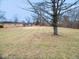 View of the lawn behind the single-story red brick home at 4530 Wichser Ct, Indianapolis, IN 46228